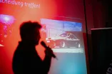 Man sieht die Silhouette einer Person, die eine Präsentation hält.