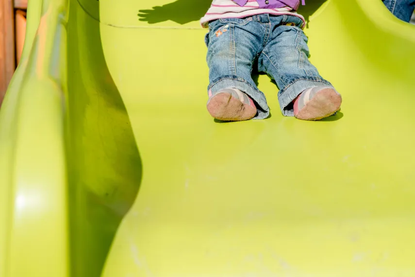 Kinderfüße auf der Rutsche