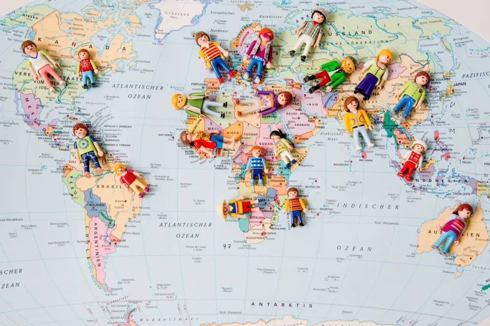 Playmobil figures on a world map