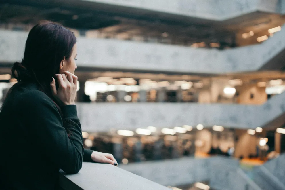 Studentin in einem brutalistischen Bauwerk
