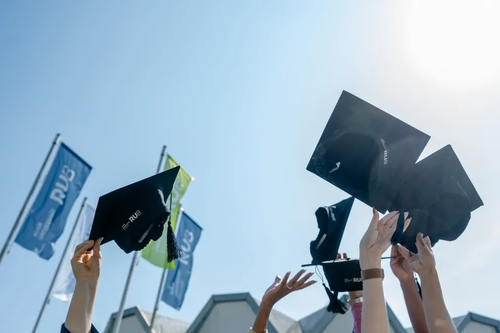A group of people throw their doctor's hats in the air.