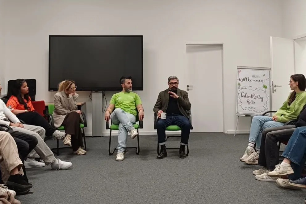 Gruppe von Schülern sprechen mit Suat 